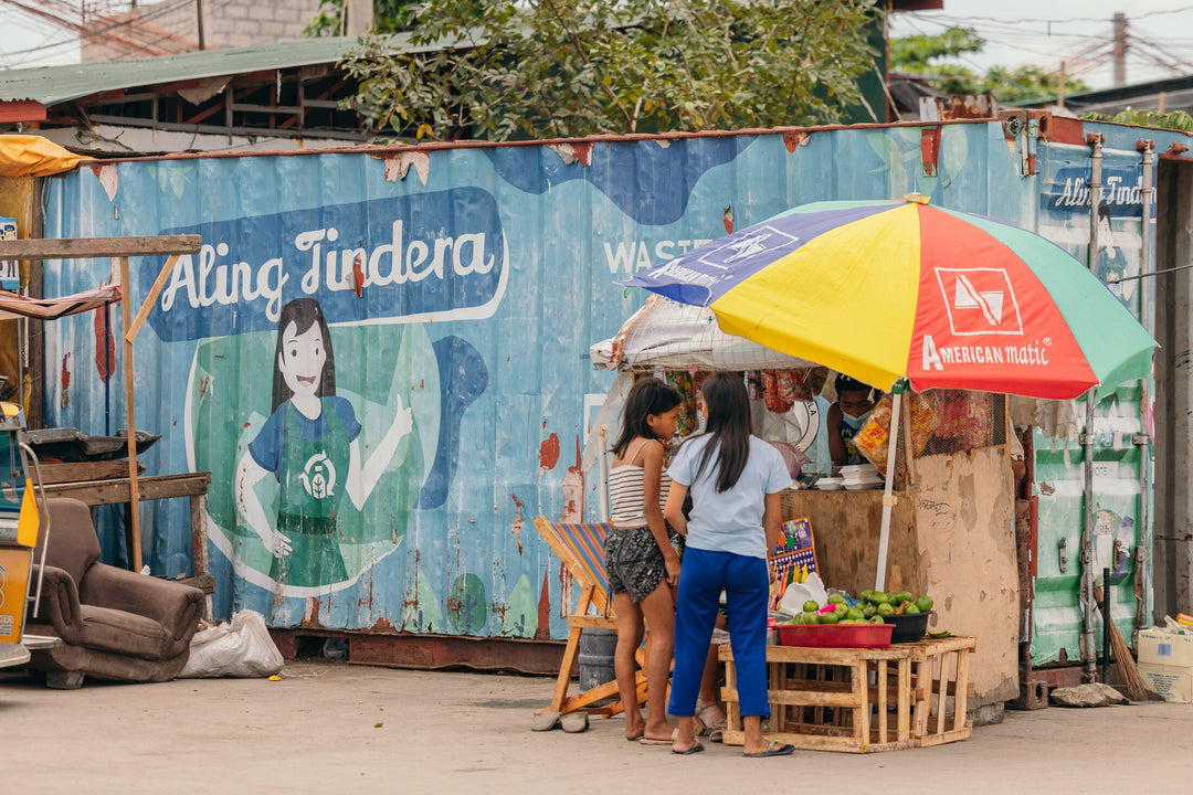 An image of women selling fruits as part of a women run plastic waste-to-cash program which organizes communities to remove all types of plastic in their communities around the Philippines 