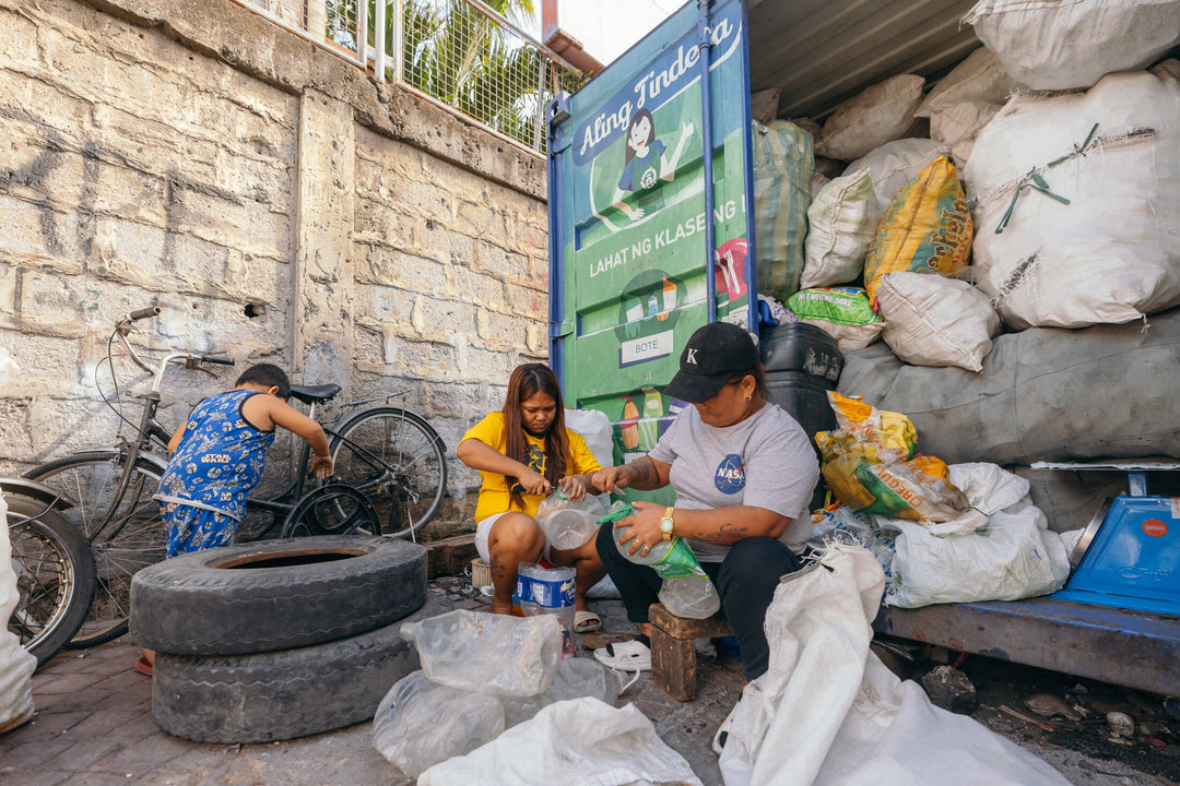 An image of women working with plastics as part of a women run plastic waste-to-cash program which organizes communities to remove all types of plastic in their communities around the Philippines 