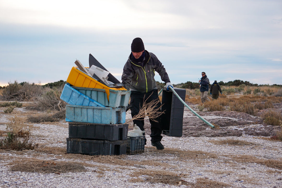 A man carries a pile of plastics that were gathered as part of a program to remove plastic waste (PP, HDPE, Nylon, and others) from the fishing industry in remote areas like Patagonia, Argentina